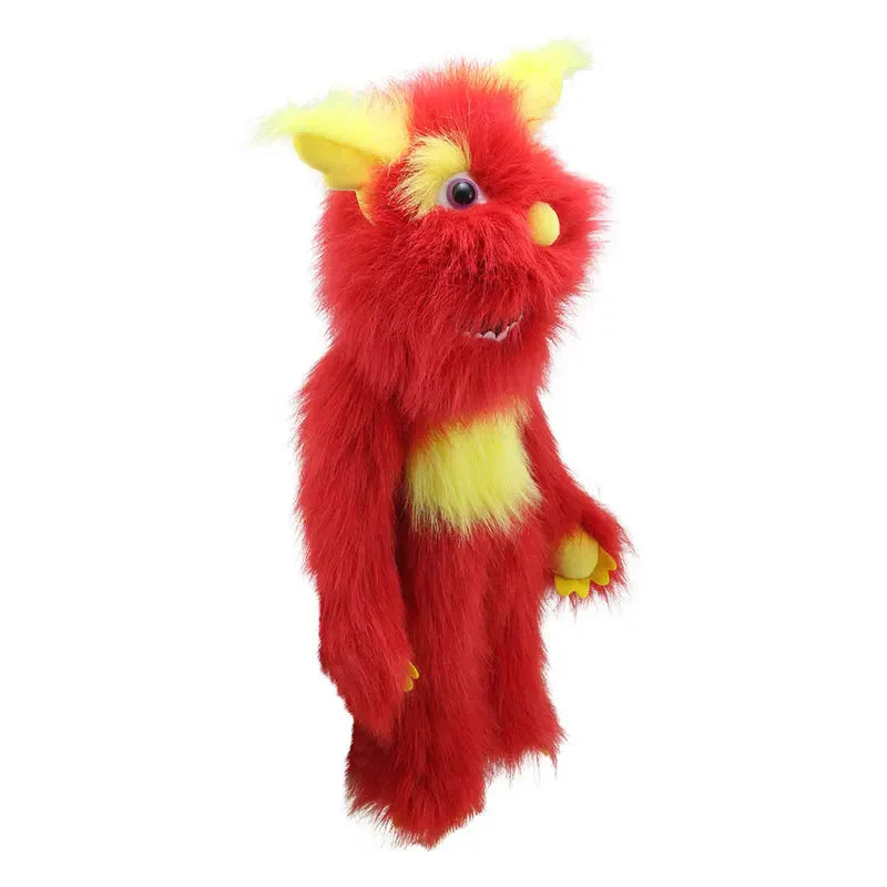 The Puppet Company Red Monster is a fuzzy puppet with bright red fur, yellow ears, hands, and chest, big round eyes, a pink nose, and a friendly look, shown standing upright against a white background.