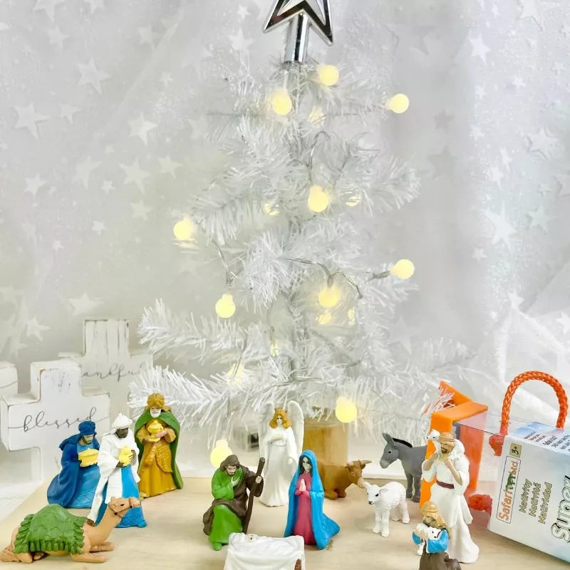 A nativity scene with TOOBS® Figurines Nativity and a christmas tree.