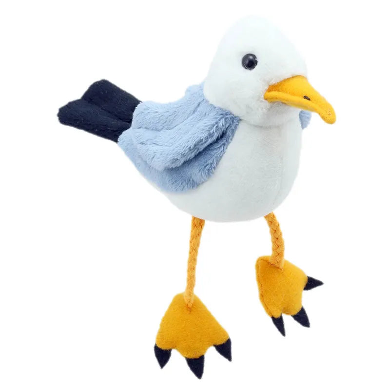 The Puppet Company Seagull Finger Puppet is ideal for creative adventures, featuring a white head, blue wings, yellow beak, and long braided yellow legs with webbed feet. Standing with a slight tilt, it's perfect for coastal storytelling and imaginative play!.