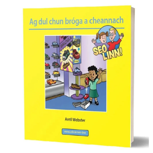 The cover of the preschool book "Seo Linn! – Scéalta Sóisialta Ag dul chun bróga a cheannach" by Avril Webster features a cheerful child trying on shoes in a store with a friendly salesperson. The background shows various shoes on display. This Irish publication is part of the "Seo Linn!" series, focusing on development skills.