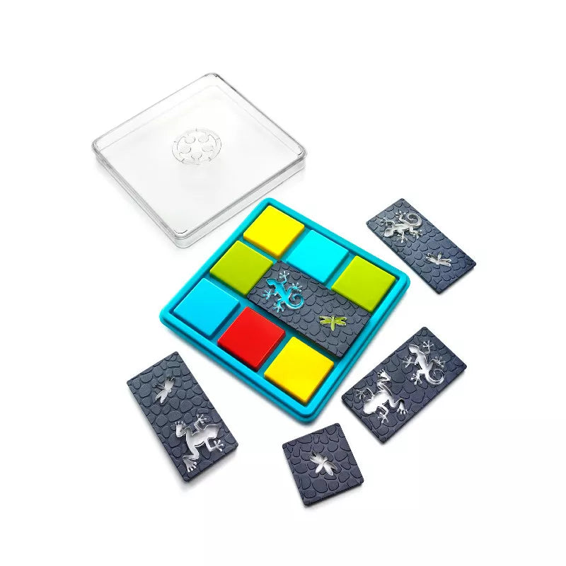 Introducing the SmartGames Colour Catch with a Damaged Box: This STEM toy puzzle game includes a grid tray filled with vibrant squares. Surrounding the tray are rectangular tiles featuring gray lizard designs, adding an educational touch. It also comes with a clear plastic cover to enhance organization and offer additional challenges, perfect for developing problem-solving skills.
