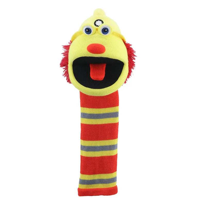 The Puppet Company Sockette Flint is a colorful, eco-friendly hand puppet made from recycled materials. It features stripes, a yellow face, googly eyes, a red nose, fuzzy red hair, and an expressive open mouth with a red tongue.