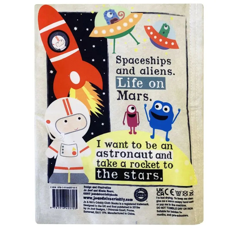 The Crinkly Cloth Book Science Museum features vibrant illustrations of rockets, spaceships, aliens, and an astronaut with the text: “Spaceships and aliens. Life on Mars. I want to be an astronaut and take a rocket to the stars.”.
