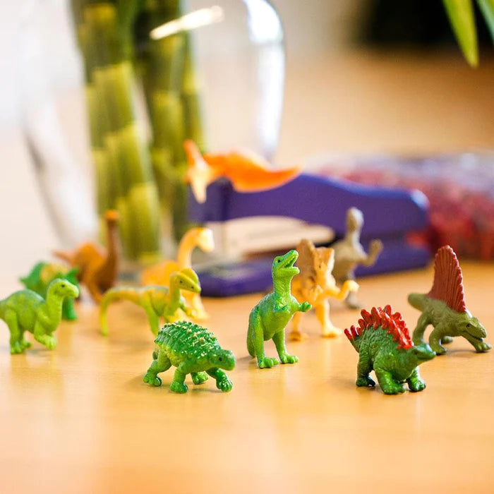 Kids' puppet show featuring TOOB® figurines of dinos on a table alongside a vase.