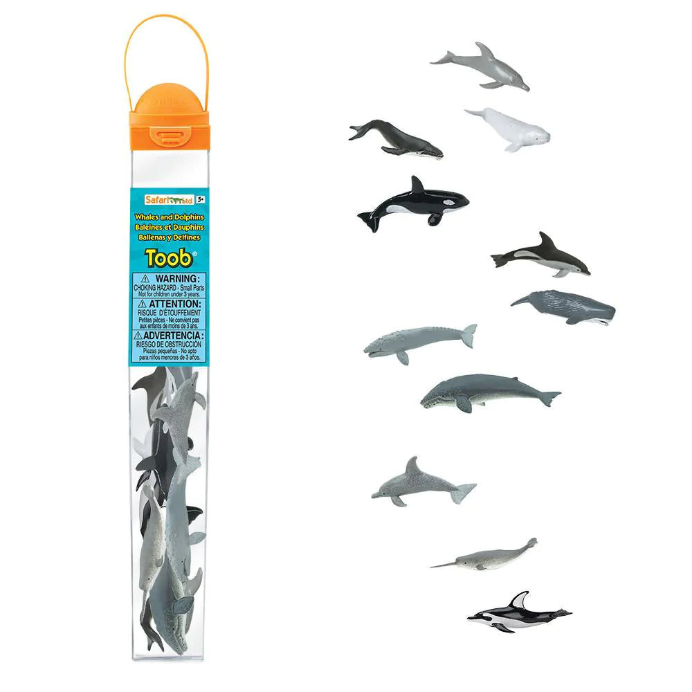 A group of whimsical kids' puppets, including TOOBS® Figurines Whales & Dolphins, on a stick bring a lively puppet show to life next to a bottle.