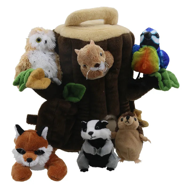 The Puppet Company Hide Away Tree House is a plush toy set with a soft tree featuring a handle and woodland character finger puppets: an owl, squirrel, colorful bird, fox, badger, and hedgehog. Each animal is realistically styled for interactive play.