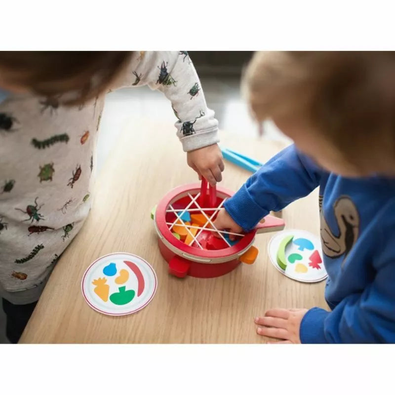 Two children playing Buitenspeel Veggie Game on a table.