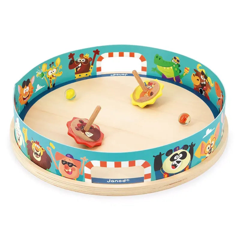 A Janod Applepop - Spinning Top Arena, perfect as a children's toy, featuring colorful animal illustrations along the circular rim. The game includes two spinning tops with handles and four small balls. The border has vibrant images of various animals enjoying the game.