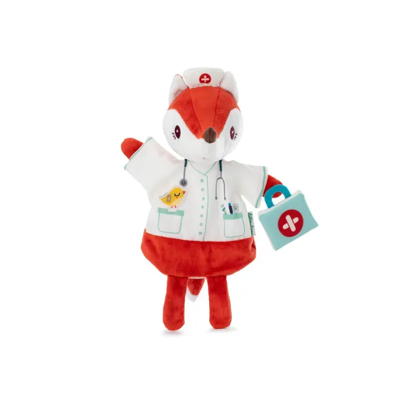 A Lilliputiens Alice Doctor Handpuppet of a red and white fox dressed as a nurse, complete with a white medical coat, a nurse's hat, and a stethoscope around its neck. Perfect for imaginative play, this delightful toy is suitable for children 2 years+. The fox is holding a blue medical bag with a red cross on it.