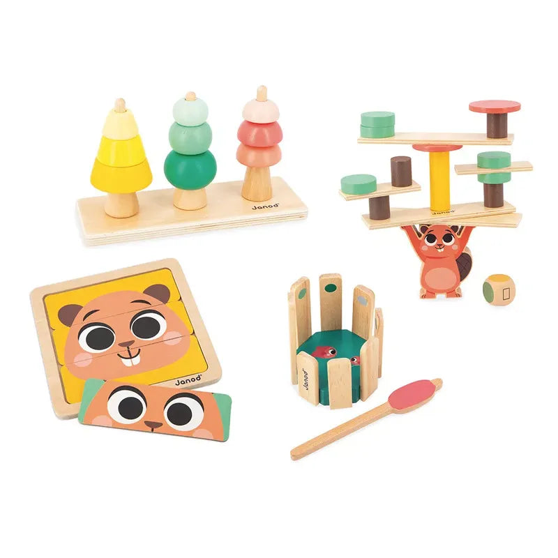 A collection of colorful wooden children's toys, including sensory stacking trees, a balancing squirrel game, a buildable squirrel, a puzzle with a smiling face, and an educational toy fishing set. All toys are placed on a white background. This is the Janod Box of Toys 36 Months.