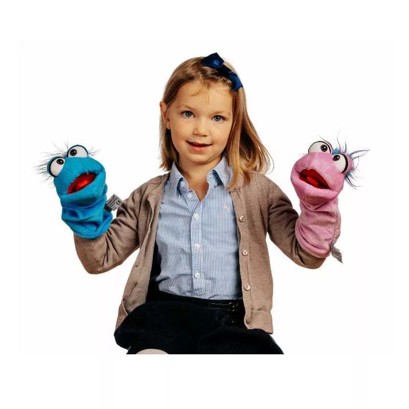 A little girl is holding two puppet puppets in her hands, ready for a fun kids' puppet show.