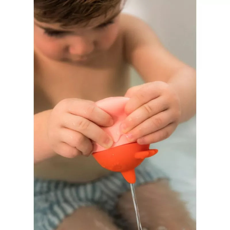 A young boy is playing with a Paulette Water sprinkler.