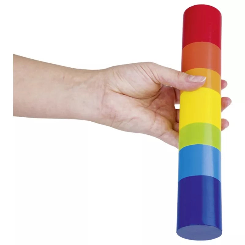 A sensory toy for 12-month-olds, featuring a hand holding the Goki Rain Stick.