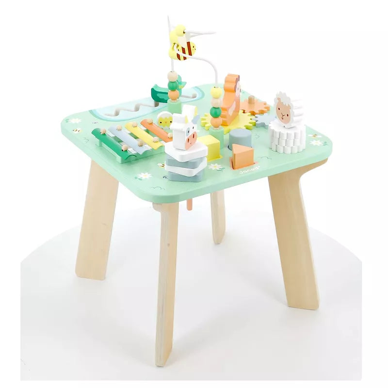A Janod Meadow Activity Table with a cake on top of it.